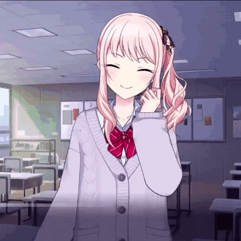 a girl with pink hair is smiling in a classroom wearing a cardigan