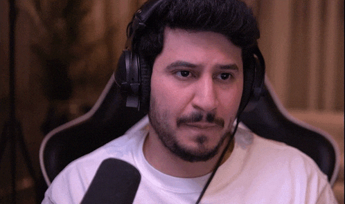 a man with a beard wearing headphones and a headset