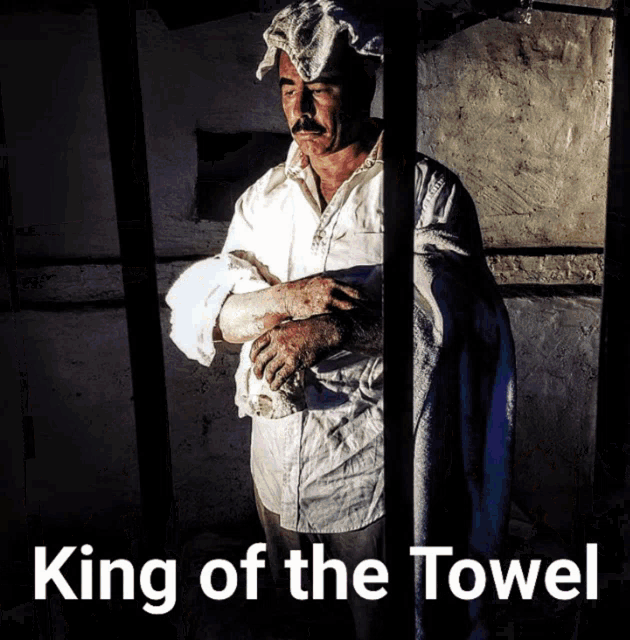 a man behind bars with a towel on his head and the words king of the towel above him
