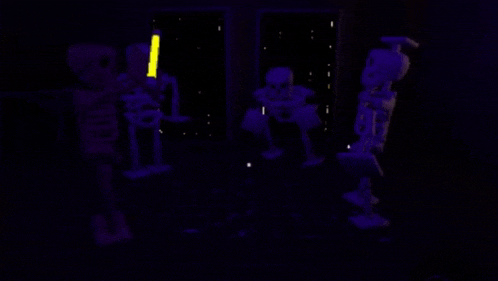 a group of skeletons are glowing in the dark in a room .