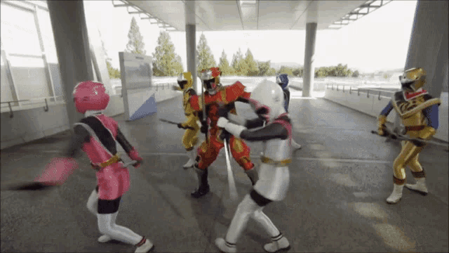 a group of power rangers are standing in a hallway