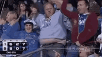 a group of people are watching a baseball game and the score is 6 27 8 07 .