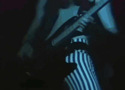 a man playing a guitar and a woman playing a guitar on stage