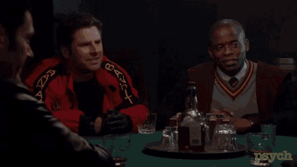 a group of men are sitting around a table with a tray of alcohol and the word psych on the bottom right corner