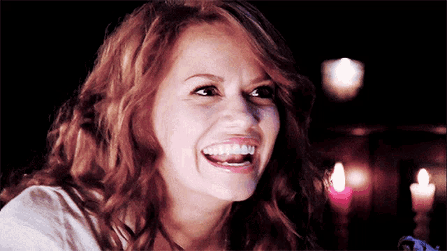 a close up of a woman 's face with a smile on her face