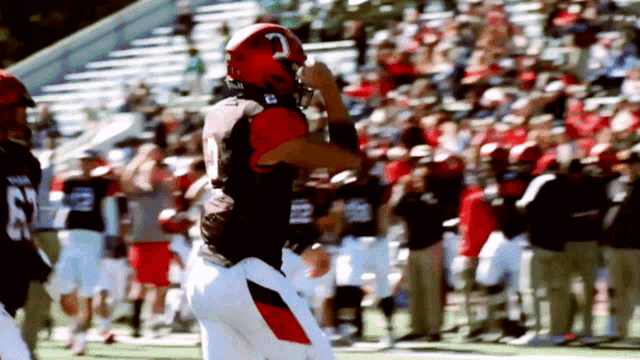 a football player wearing a helmet with the letter g on it