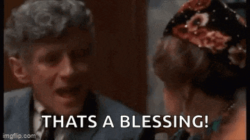 a man in a suit and tie is touching a woman 's ear and saying `` thats a blessing ! ''