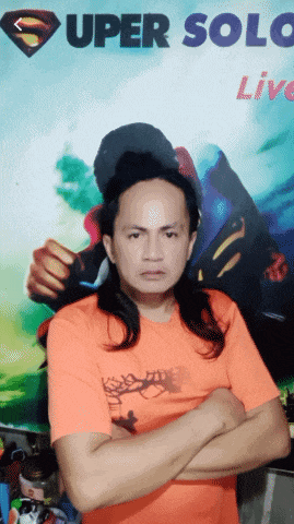 a man with his arms crossed in front of a super solo live poster