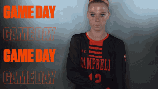 a girl wearing a campbells jersey stands in front of a game day sign