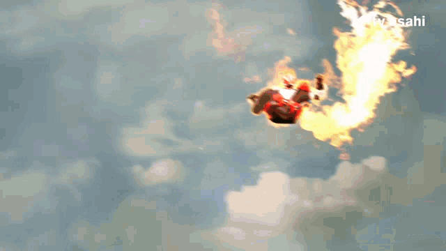 a person flying through the air with a tv asahi logo in the background