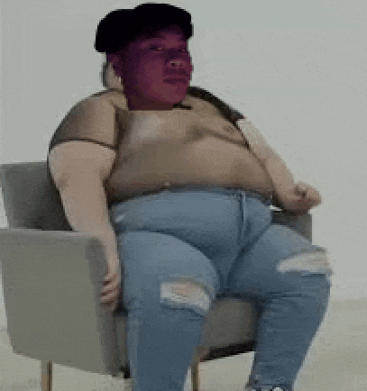 a very fat person is sitting in a chair with a purple face .