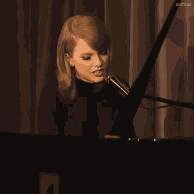 a woman singing into a microphone with the words i remember underneath her