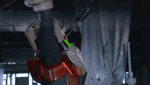 a robot with a green light coming out of it 's arm