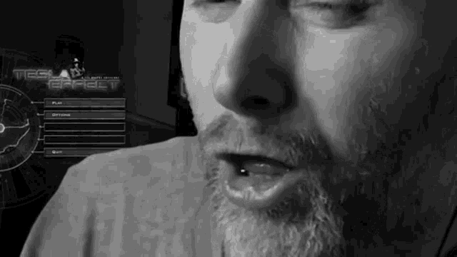 a man with a beard is looking at a screen that says tesla effect