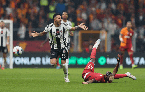 a soccer player with the number 53 on his jersey is running towards the ball
