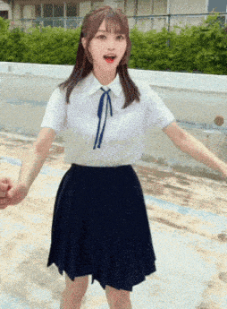 a girl in a white shirt and blue skirt is holding a man 's hand