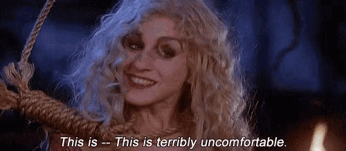 a woman is hanging from a rope and smiling while saying `` this is terrible uncomfortable . ''