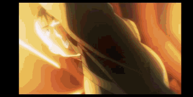 a close up of a person holding a sword in a dark room