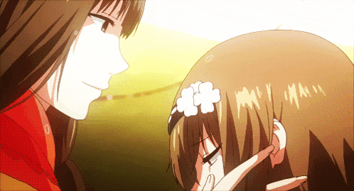 a girl with a flower in her hair touches another girl 's ear