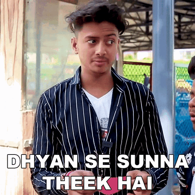a young man in a striped shirt says dhyan se sunna theek hai on the bottom