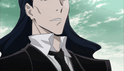 a man with long black hair and a suit and tie
