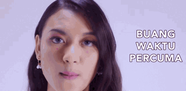 a close up of a woman 's face with the words " buang waktu percuma " on the bottom