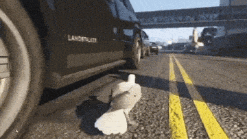 a black land rover is parked on the side of the road .