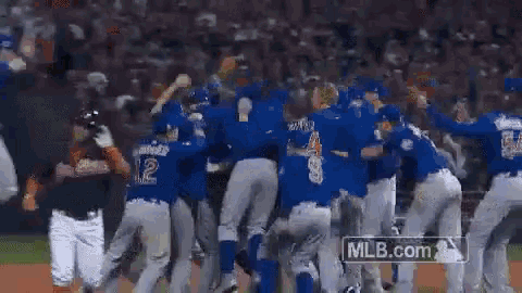 a group of baseball players are celebrating on a field with mlb.com in the background