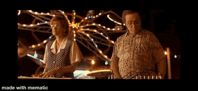 a man and woman are standing in front of a ferris wheel at a carnival