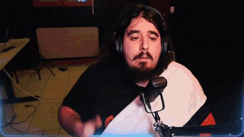 a man with a beard wearing headphones and a towel around his neck