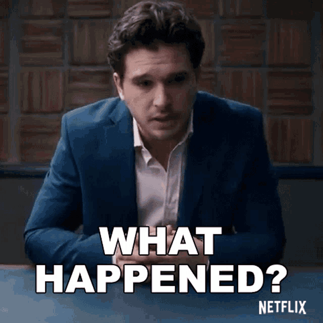 a man in a suit is sitting at a table with the words " what happened " written on it