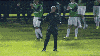 a group of soccer players standing on a field