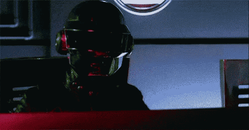 a man wearing a helmet and headphones is looking at something