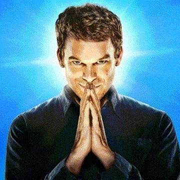 a man in a black shirt is praying with his hands folded