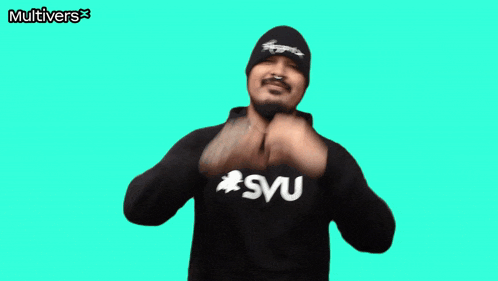 a man making a heart shape with his hands wearing a sweatshirt that says " svu "
