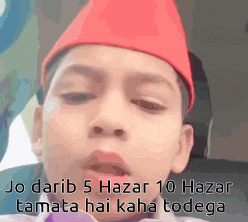 a young boy wearing a red hat with the words jo darib 5 hazar 10 hazar tamata hai kaha todega below him
