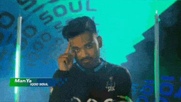 a man with the name manya iq00 soul on his shirt
