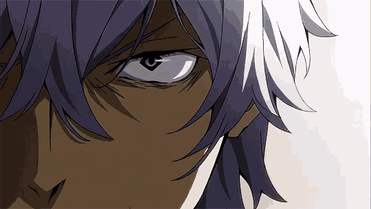 a close up of a person 's face with a serious look on his face