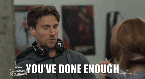 a man wearing headphones says " you 've done enough " in front of a woman