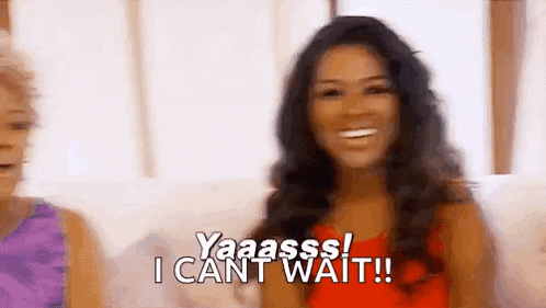 a woman is sitting on a couch and smiling while another woman says `` i can 't wait ! ''