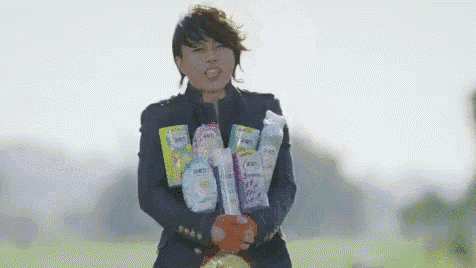 a man in a suit is holding a bag of diapers and a bottle of water .
