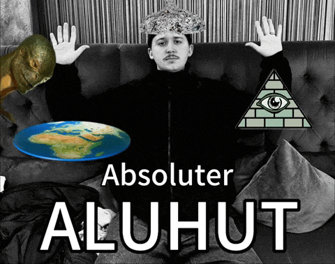 a man sitting on a couch with a pyramid and a flat earth
