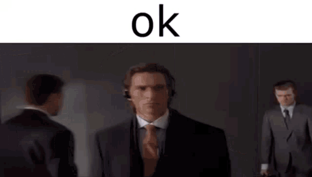 a man in a suit and tie is wearing headphones while standing in a room .
