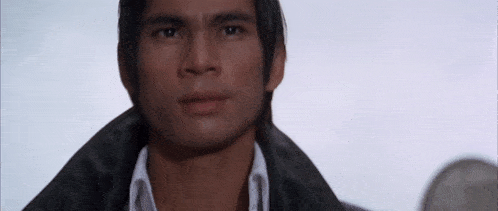 a man wearing a black leather jacket and a white shirt