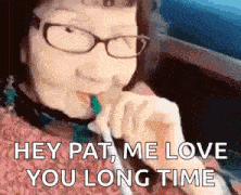 a woman with glasses is smoking a cigarette and saying `` hey pat me love you long time '' .