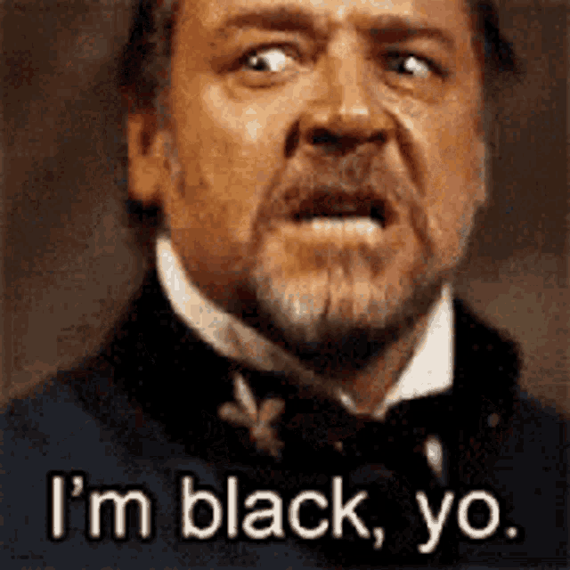 a man with a beard is making a face and saying i 'm black , yo .