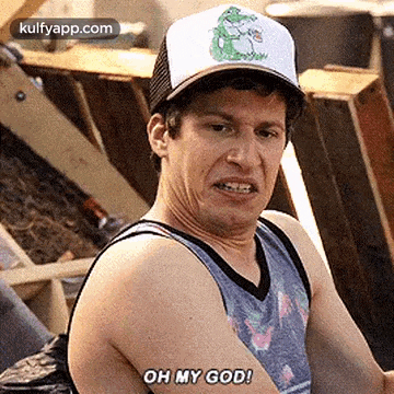 a man wearing a hat and tank top is making a funny face .