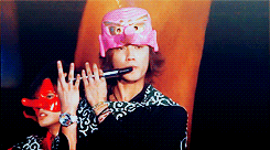 a man wearing a pink hat holds a microphone