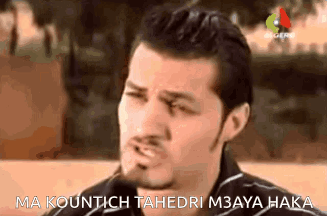 a close up of a man 's face with the words ma kountch tahedri m3aya hakka written below him