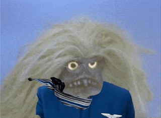 a person in a blue uniform has a tie around their neck and a monster behind them